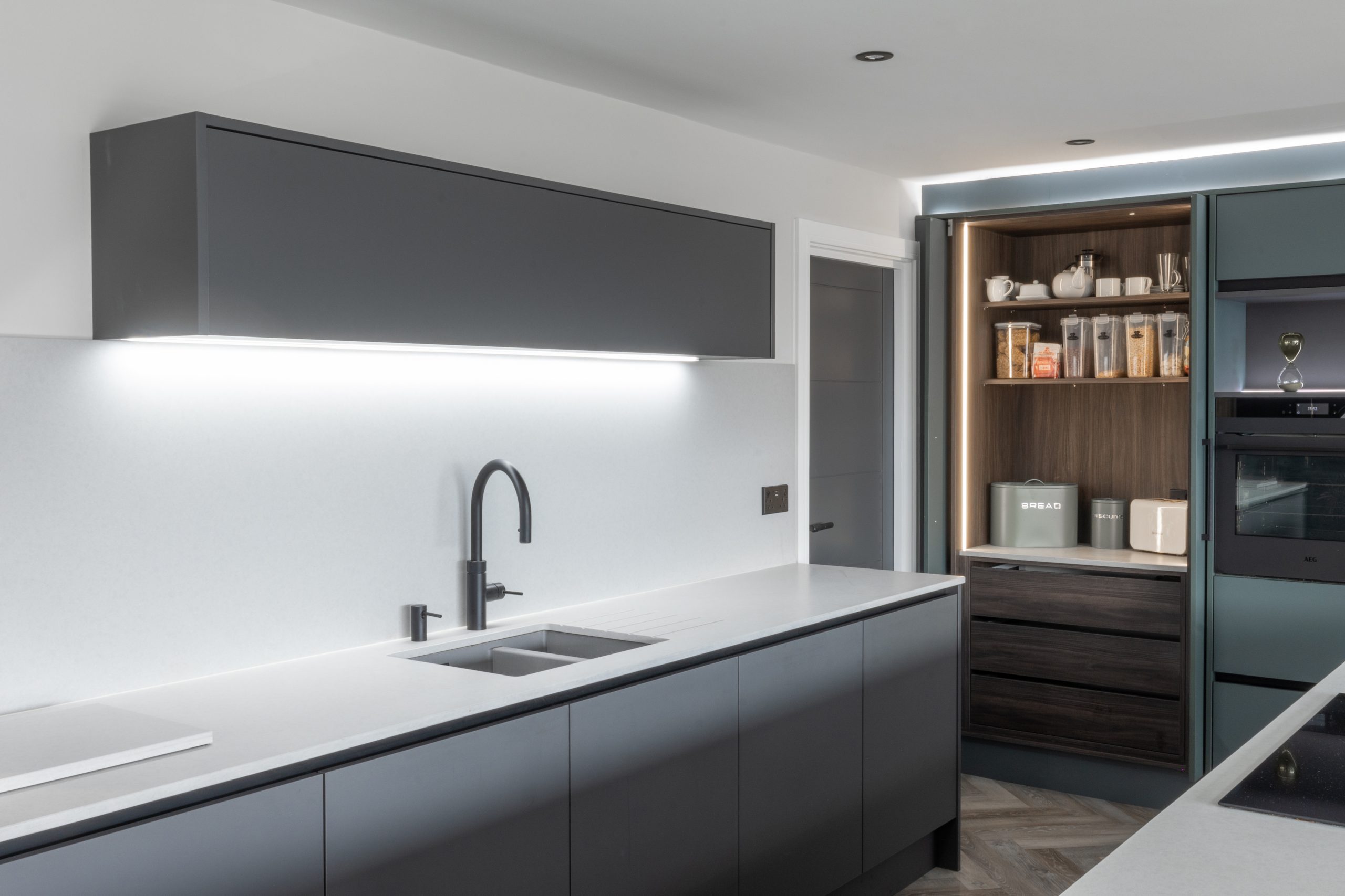 kitchen with white worktops and grey cupboard doors