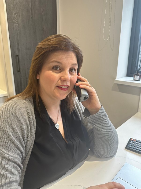 Julie on the phone at her desk