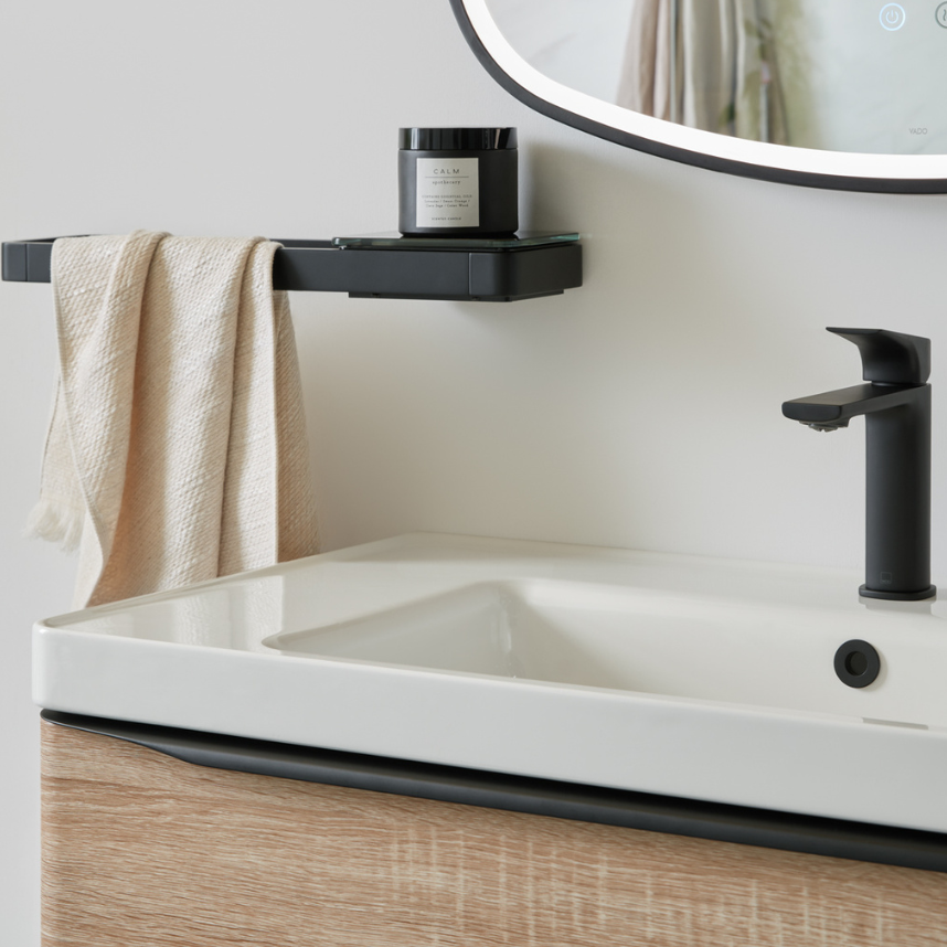 white sink with black tap and shelf