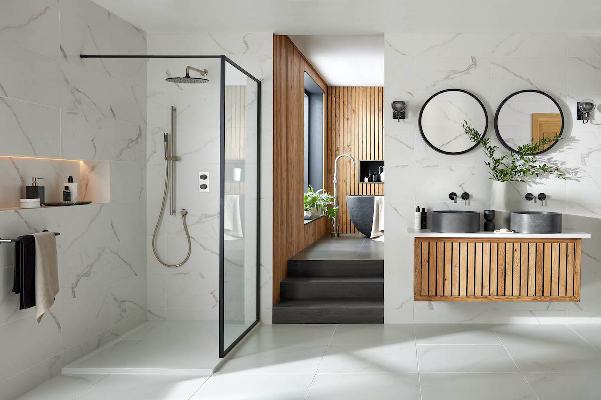 white bathroom with a big walk in shower, featuring his and her sinks