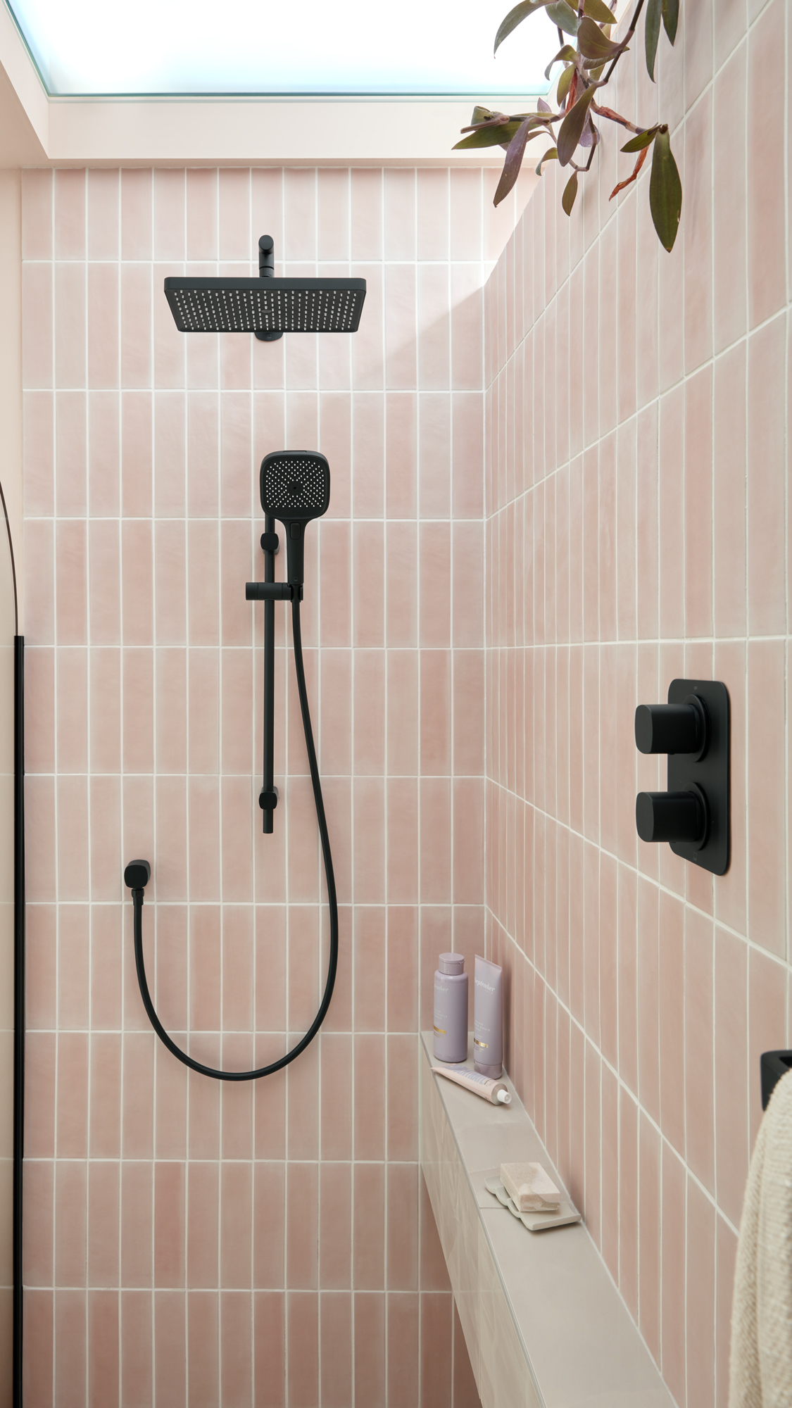 pink tiled shower with black accents