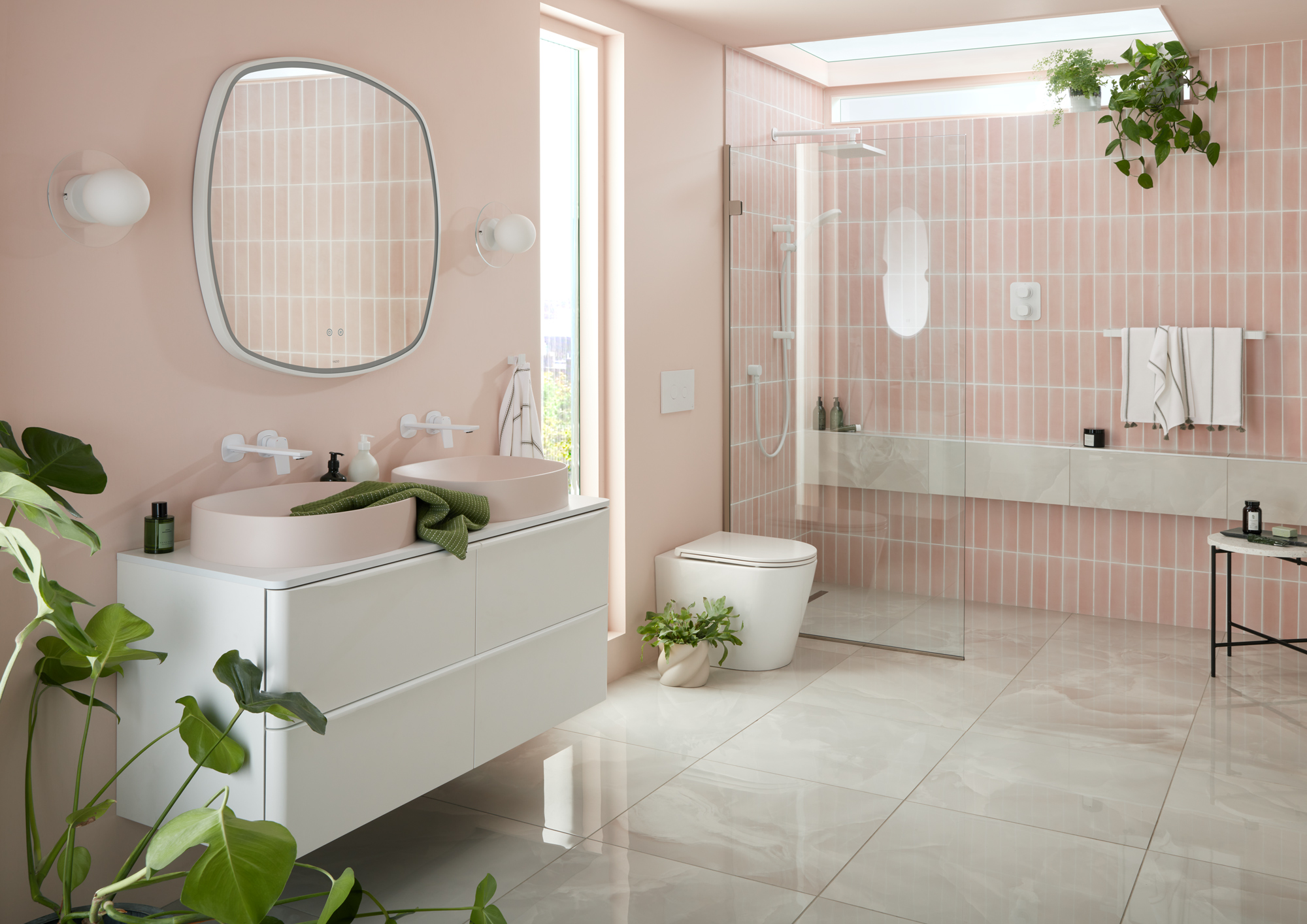 pink tiled bathroom with white cabinetry