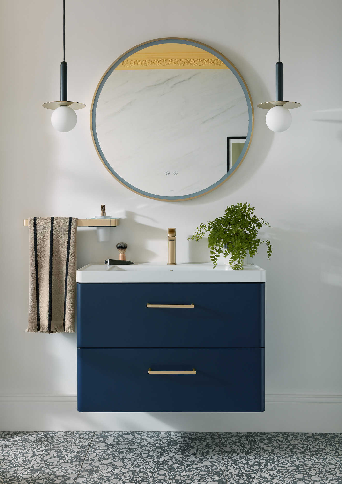 blue drawers under a sink with a big circular mirror