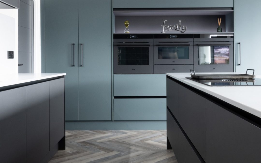 black and green kitchen with built in AEG ovens