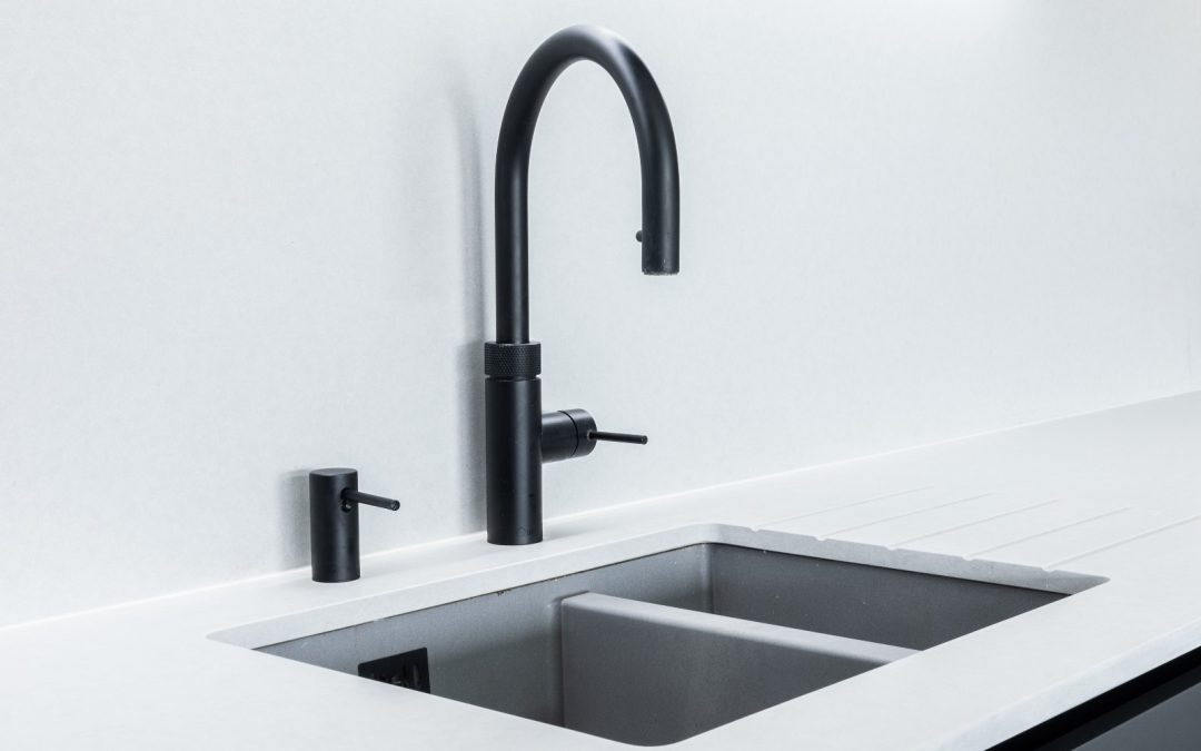 black quooker tap with a white worktop