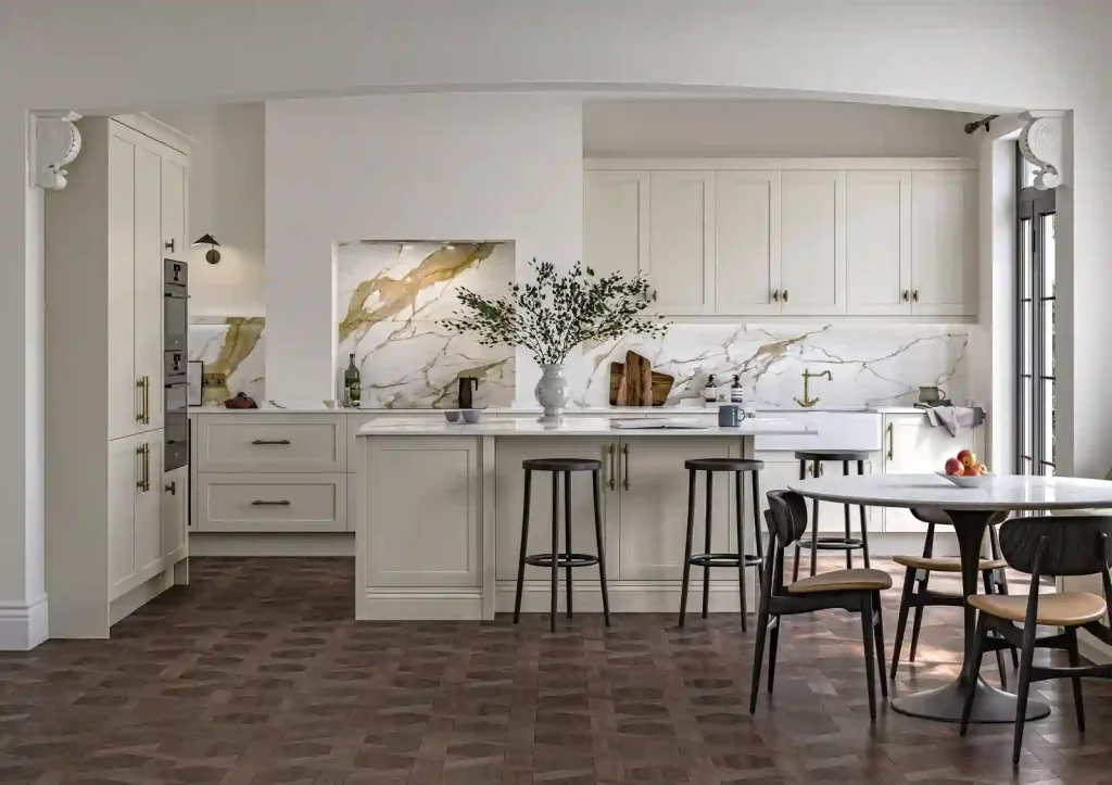 Warm off-white cabinetry against the gold-veined slab shows warmth applied at premium scale